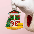 Load image into Gallery viewer, Decorative Christmas ornament shaped like a house with festive elements, held by a white glove on a pink background.
