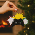 Load image into Gallery viewer, Personalized gamer controller Christmas ornament featuring a raised 3D front with detailed game controller design, including realistic buttons, joystick elements, and bold comic style accents. The ornament has a smooth flat 2D back for easy hanging and long lasting durability on the Christmas tree. The design allows personalization with a name and year clearly displayed on the front, making it a unique holiday keepsake. Bright colors and gaming themed details make this ornament perfect for kids, teens, and 
