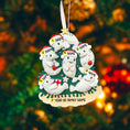 Load image into Gallery viewer, Personalized Christmas ornament with polar bears in a wreath on a blurred Christmas tree background.

