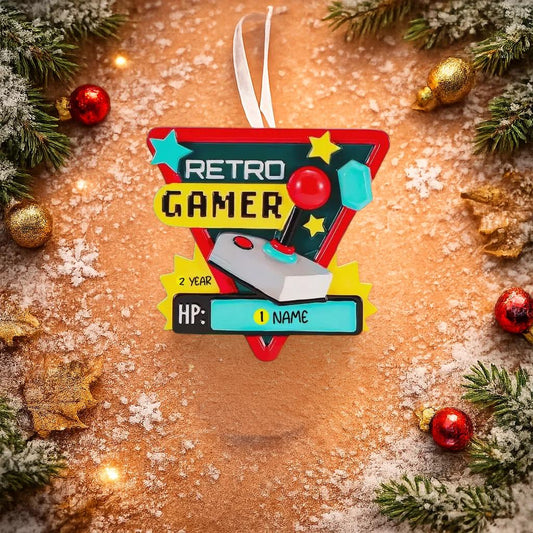 Personalized retro gamer Christmas ornament featuring a classic arcade style joystick and bold gaming icons. Raised 3D front details create depth while the back remains flat for easy hanging. Custom name and year placement make this ornament a fun and nostalgic keepsake for gamers and holiday tree decor.