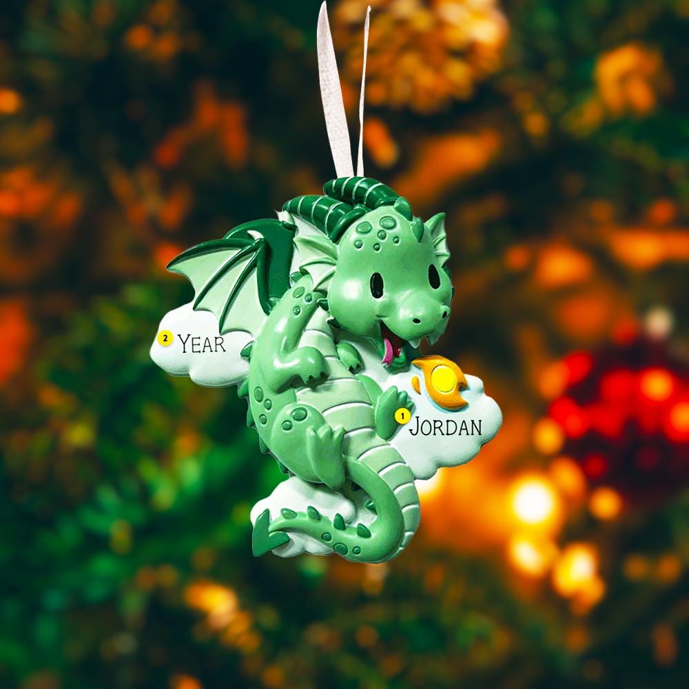 green dragon ornament designed with a fully sculpted 3D front that showcases raised details and expressive features, paired with a smooth 2D flat back for lightweight hanging. The glossy finish enhances the depth of the front design while keeping the back clean and minimal. Personalized name and year placement are clearly visible, making this dragon ornament a magical keepsake and a charming addition to holiday decor or fantasy themed collections.