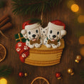 Load image into Gallery viewer, Personalized Christmas dog ornament featuring two adorable dalmatian puppies sitting together on a cozy basket, each wearing a Santa hat and holding a bone. Both puppies can be customized with names, while the front of the basket is personalized with a year or family name. Decorated with festive details like a stocking, gift box, and holiday accents, this ornament has a raised 3D front and smooth finish, making it perfect for dog lovers, couples, families, and Christmas tree decor.

