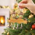 Load image into Gallery viewer, Hand holding a moose-shaped Christmas ornament with a blank plaque against a decorated tree background.
