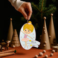 Load image into Gallery viewer, Personalized ballet girl Christmas ornament featuring a cute ballerina character in a pink tutu dress with heart details, customizable name area on the front banner and customizable year area below, glossy finish with raised 3D front details and flat 2D back, white hanging ribbon, displayed on a snowy holiday background with pine branches and festive decorations.
