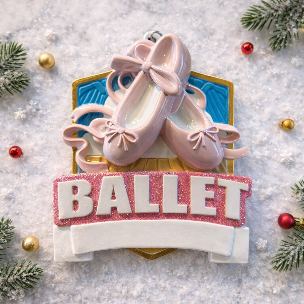 Personalized ballet Christmas ornament featuring soft pink ballet shoes with delicate ribbon details and a glittered ballet banner, customizable name area on the lower front ribbon and customizable year area beside the name, glossy finish with raised 3D front elements and flat 2D back, white hanging ribbon, displayed on a warm snowy holiday background with festive greenery ornaments and cozy Christmas decor.