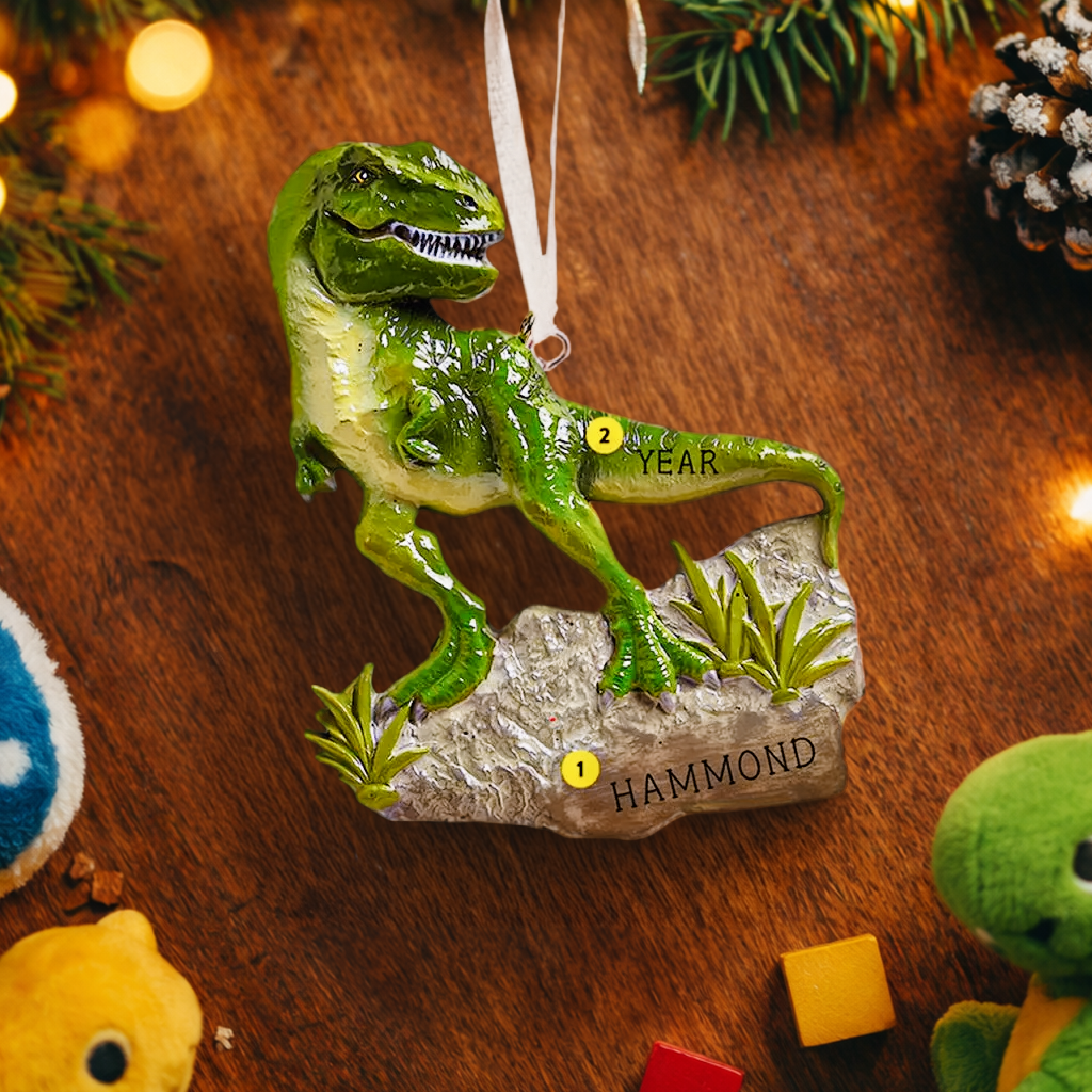 Realistic dinosaur themed Christmas ornament featuring a detailed T-Rex design with vibrant green tones and a playful yet bold appearance. Styled in a warm holiday setting, this ornament is designed to be personalized and makes a fun keepsake for kids who love dinosaurs and adventure themed decorations