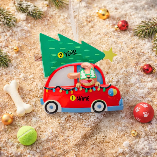 Festive dog themed Christmas ornament featuring a happy puppy riding in a red car with a Christmas tree on top. Designed with playful holiday colors and a cozy winter setting, this ornament brings a joyful pet themed touch to Christmas tree decor. Includes personalization options for name and year, making it a meaningful keepsake for dog lovers and pet families.