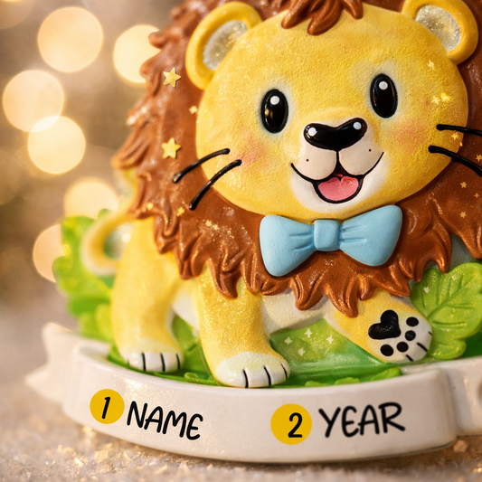 A cute lion themed Christmas ornament designed with a playful and colorful style, perfect for kids and animal lovers. This ornament features a friendly lion character standing on a grassy base with a glossy finish and cheerful details. The design includes a personalization option, allowing a custom name and year to be added, making it a meaningful keepsake for children or family holiday traditions. Ideal for Christmas trees, nursery decor, or as a unique personalized gift for animal themed celebrations.