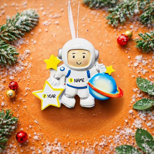 Personalized astronaut Christmas ornament featuring a detailed 3D front design with a smiling space explorer holding a colorful planet and bright yellow stars. The child’s name is added on the suit and the year is written on the star for a custom touch. This space themed ornament is perfect for kids who love rockets, planets, and outer space dreams. A fun and meaningful holiday keepsake for future astronauts and little space lovers.