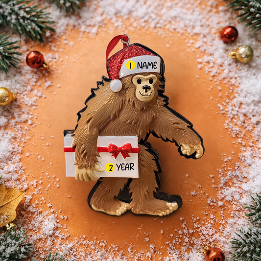 This playful Bigfoot Christmas ornament features a cheerful sasquatch character wearing a Santa hat and holding a gift, finished with a glossy surface that highlights the raised details and festive colors. The design brings a fun and whimsical holiday vibe, making it a standout decoration for Christmas trees, shelves, or seasonal displays, especially for Bigfoot lovers and collectors of unique holiday ornaments.
