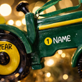 Load image into Gallery viewer, Green tractor ornament featuring a classic farm tractor design with a deep green glossy finish and yellow wheel details. The ornament includes free handwritten personalization with one name and one year, making it a meaningful keepsake for farm families and tractor loving children. Inspired by country life and rural traditions, this ornament is perfect for farmhouse Christmas decor and personalized holiday displays.

