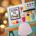 Load image into Gallery viewer, Born to Craft ornament featuring a creative desk scene with colorful craft supplies including scissors paint bottles brushes pencils and storage cups. The ornament showcases a playful crafting workspace design with a modern chair and desk setup. Made from durable resin with a detailed 3D front and flat 2D back for smooth hanging. Includes free handwritten personalization making it a perfect gift for crafters artists DIY lovers and creative kids. Ideal for Christmas trees craft rooms studios and handmade the
