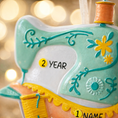 Load image into Gallery viewer, Personalized sewing machine ornament featuring a charming vintage style design with soft pastel colors and floral details. The ornament includes space for a name and year, making it a meaningful keepsake gift. Crafted from durable resin with a detailed 3D raised front and flat 2D back for smooth hanging. Includes free handwritten personalization. A perfect Christmas ornament gift for grandmothers sewing lovers quilters crafters and anyone who enjoys handmade traditions and creative hobbies.
