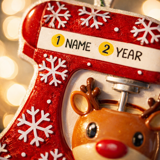 Personalized baking ornament featuring a festive red stand mixer design with snowflake details and a cute reindeer bowl accent. Finished with a smooth glossy surface and holiday inspired colors. Includes free handwritten personalization with one name and year displayed on the mixer. Designed with a raised 3D front and flat back for easy hanging. Styled in a cozy Christmas setting with snow greenery and ornaments, perfect for bakers home cooks and holiday keepsakes.