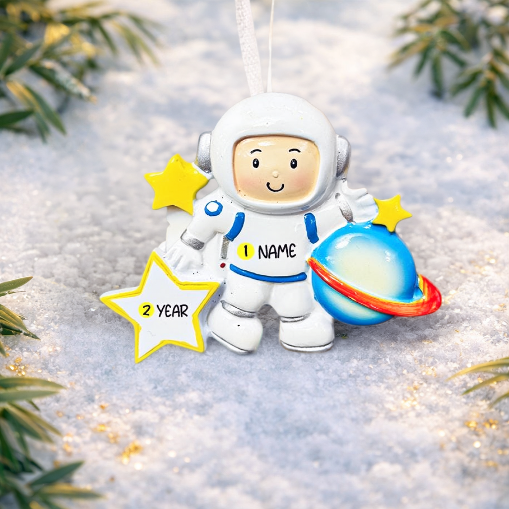 Personalized astronaut Christmas ornament featuring a detailed 3D front design with a smiling space explorer holding a colorful planet and bright yellow stars. The child’s name is added on the suit and the year is written on the star for a custom touch. This space themed ornament is perfect for kids who love rockets, planets, and outer space dreams. A fun and meaningful holiday keepsake for future astronauts and little space lovers.