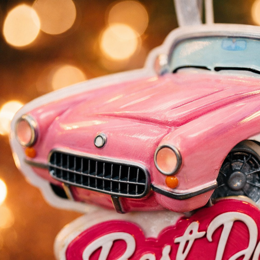 Personalized pink convertible car Christmas ornament with custom name detail and “Best Day Ever” text. This retro style pink car holiday ornament features raised 3D front details and a lightweight flat back design, perfect for Christmas tree décor. A fun keepsake gift for girls, car lovers, birthdays, graduations, or celebrating a special milestone during the holiday season.