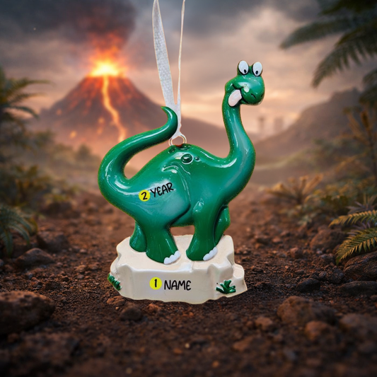 Green dinosaur ornament with '2 YEAR' and 'NAME' text on a prehistoric background