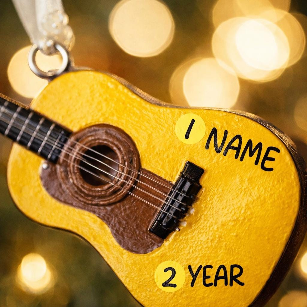 Personalized guitar ornament featuring a classic acoustic guitar design with detailed strings and wood texture. Custom name and year handwritten directly on the guitar body. High detail 3D resin ornament with white hanging ribbon. Perfect Christmas tree decoration for guitar players musicians music lovers and acoustic guitar fans. Warm musical theme ideal for holiday decor and meaningful personalized gifts.