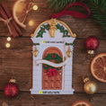 Load image into Gallery viewer, Decorative house ornament with Christmas decorations on a wooden surface.
