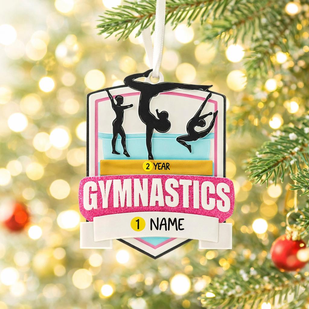 Personalized gymnastics Christmas ornament featuring elegant gymnast silhouette figures in motion, customizable name area on the front banner and customizable year area above the banner, glossy finish with raised 3D front details and flat 2D back, white hanging ribbon, displayed on a soft pink snowy holiday background with festive ornaments greenery and warm Christmas decor.
