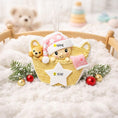 Load image into Gallery viewer, Personalized Baby Girl First Christmas Ornament featuring a detailed 3D front design with a sweet baby resting inside a woven basket, pink nightcap, teddy bear, and hanging star for the year. The baby’s name is added on the hat and the year on the star, creating a meaningful keepsake. Soft pink tones, cozy textures, and dimensional elements make it perfect for newborn girl gifts, baby shower presents, and treasured first Christmas tree memories.
