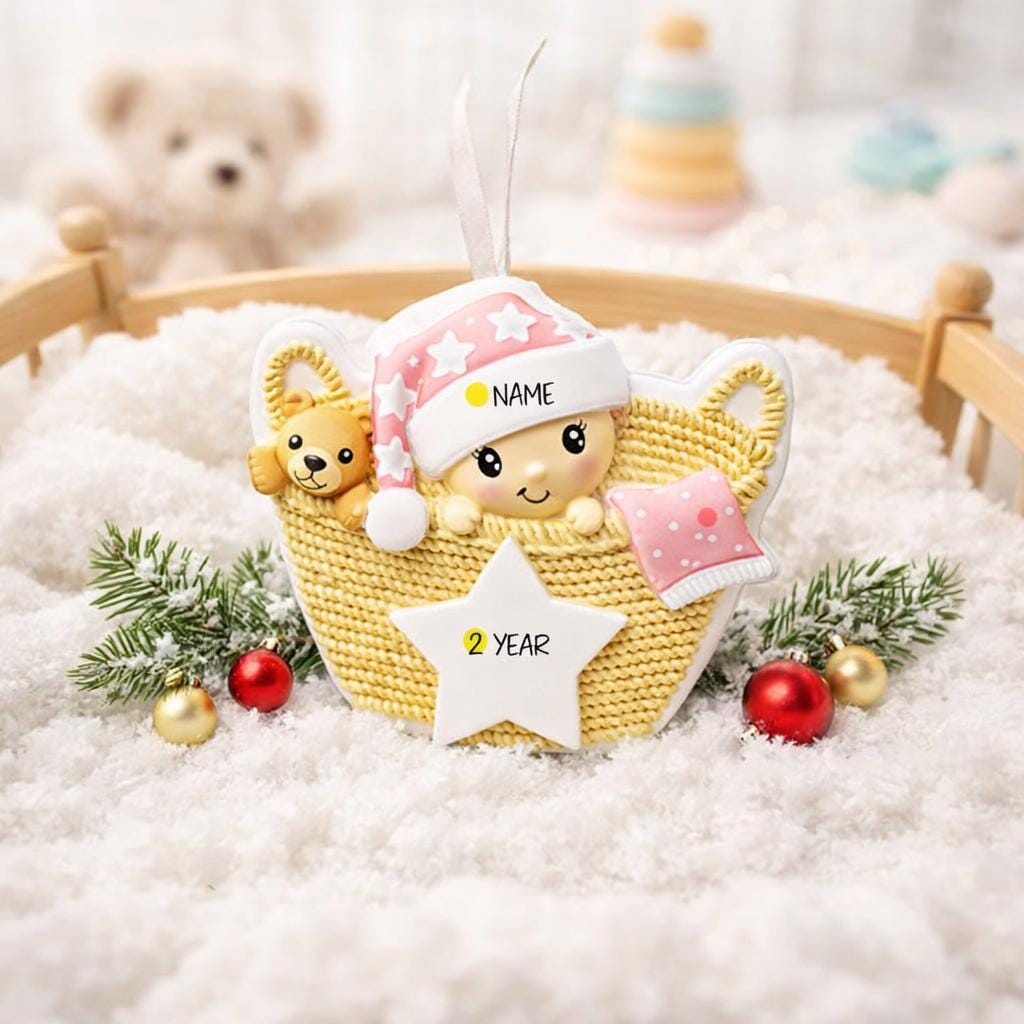 Personalized Baby Girl First Christmas Ornament featuring a detailed 3D front design with a sweet baby resting inside a woven basket, pink nightcap, teddy bear, and hanging star for the year. The baby’s name is added on the hat and the year on the star, creating a meaningful keepsake. Soft pink tones, cozy textures, and dimensional elements make it perfect for newborn girl gifts, baby shower presents, and treasured first Christmas tree memories.