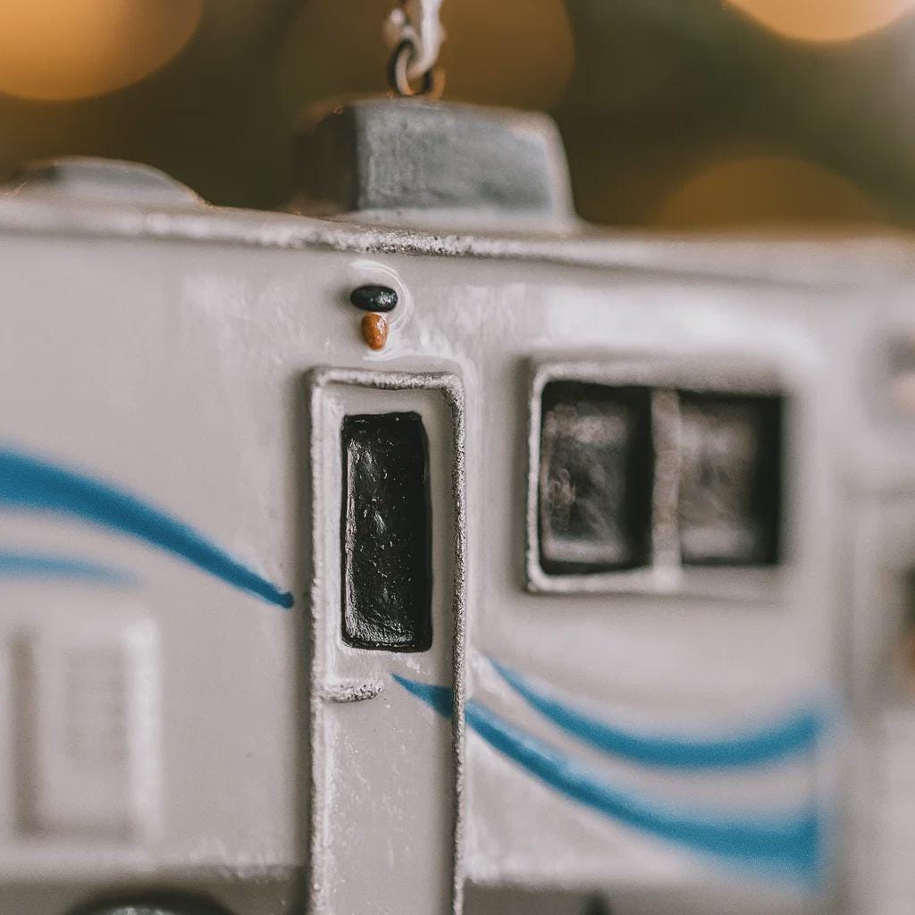 Decorative ornament resembling a vintage camera with a blurred bokeh background