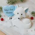 Load image into Gallery viewer, White fox figurine with a blue heart that says 'Baby's First Christmas' on a snowy background.
