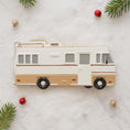 Load image into Gallery viewer, Decorative camper ornament on a snowy background with Christmas decorations.
