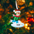 Load image into Gallery viewer, This personalized ice skating boy ornament features a cheerful winter skater wearing festive holiday clothing and gliding across an icy base. The design includes a custom name on the hat and a year displayed on the base, making it a perfect keepsake for celebrating winter memories, first Christmas moments, or a child’s love for ice skating and winter sports.

