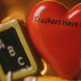 Load image into Gallery viewer, Red heart-shaped object with 'Teachers Have Hart' text and a small chalkboard with letters.
