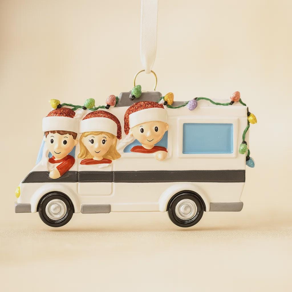 Decorative Christmas ornament shaped like a camper with three animated characters inside on a beige background.