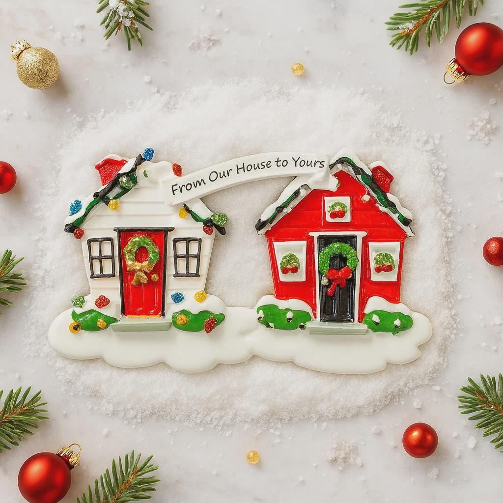 Decorative Christmas ornament shaped like a house with 'From Our House to Yours' text, surrounded by festive decorations on a snowy background.