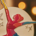 Load image into Gallery viewer, Decorative ornament with a red figure and gold accents on a blurred background
