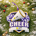 Load image into Gallery viewer, Decorative ornament with megaphone and pom-poms on a green background with snow and decorations.
