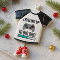 Load image into Gallery viewer, Decorative ornament shaped like a t-shirt with 'Leveling Up to Big Bro' text, surrounded by Christmas decorations.
