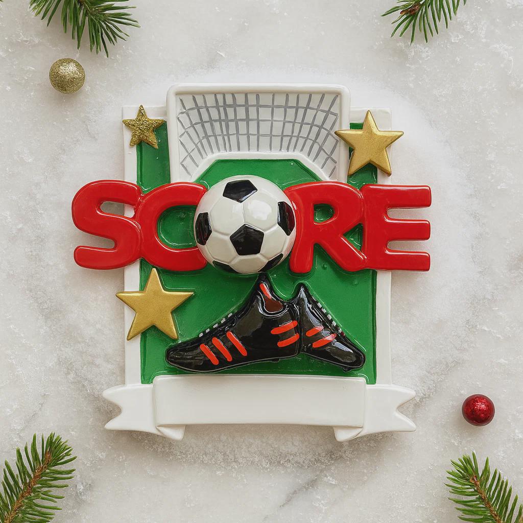 Decorative Christmas ornament with soccer ball, shoes, and 'Score' text on a light background.