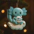 Load image into Gallery viewer, Decorative ornament with a cartoon axolotl holding a heart-shaped sign on a Christmas tree.
