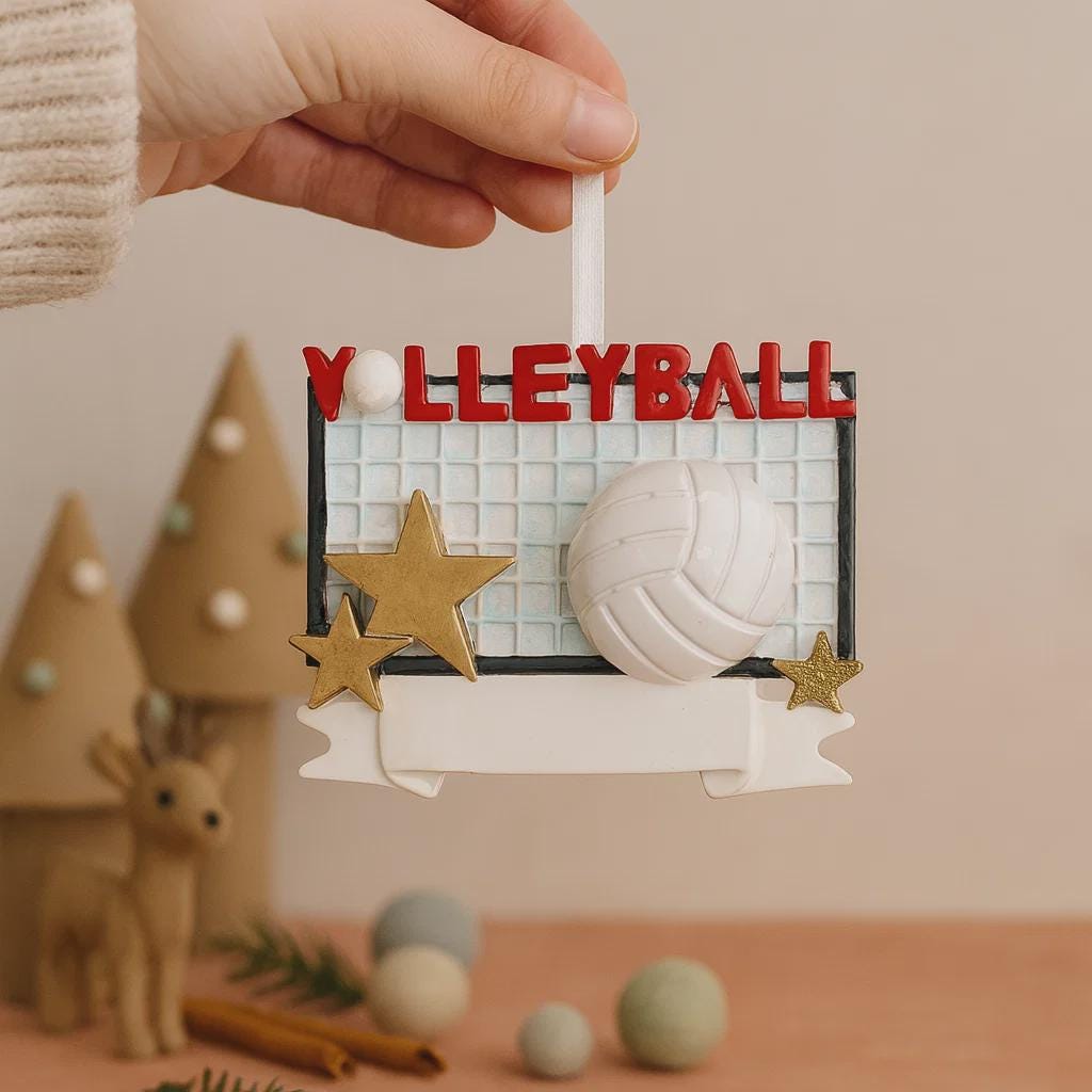Decorative ornament with 'Volleyball' text and net design, held by a hand.