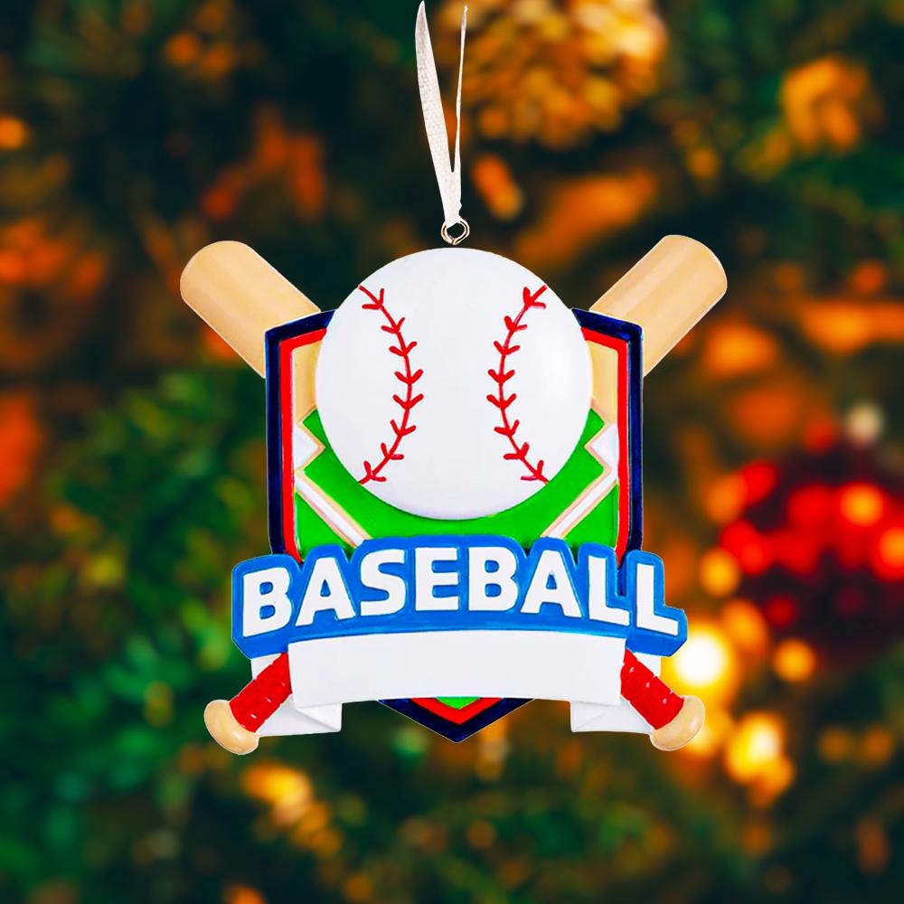 Personalized baseball Christmas ornament featuring a classic baseball and crossed bats design on a shield style background, customizable name area on the front banner and customizable year area on the baseball, glossy finish with raised 3D front details and flat 2D back, white hanging ribbon, displayed on a snowy baseball field themed holiday background with pine branches and festive decorations.