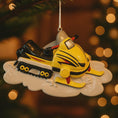 Load image into Gallery viewer, Yellow snowmobile ornament on a tree with blurred lights in the background
