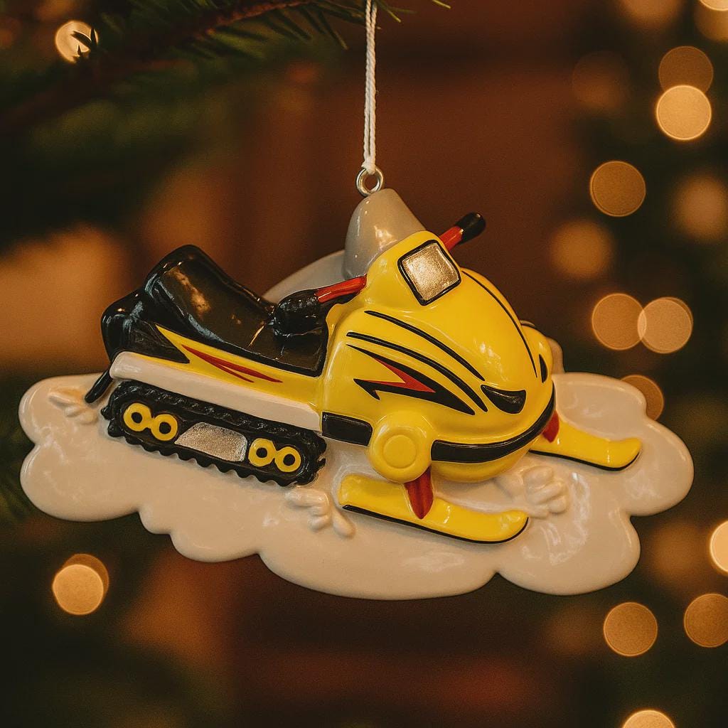 Yellow snowmobile ornament on a tree with blurred lights in the background