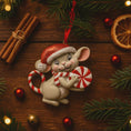 Load image into Gallery viewer, Christmas-themed ornament of a mouse with candy canes on a wooden surface with festive decorations.
