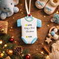 Load image into Gallery viewer, Personalized Baby’s First Christmas Ornament designed as a sweet baby bodysuit with soft blue polka dot sleeves and trim. This ornament features a raised 3D front with textured details and dimensional edges for a charming keepsake look. The baby’s name is added at the top and the year below, creating a meaningful newborn memory gift. Perfect for baby boy first Christmas, newborn celebration, holiday tree decor, and special family milestone ornament.
