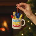 Load image into Gallery viewer, Personalized teacher ornament designed as a white mug filled with classroom tools including scissors ruler pencil and marker. The front reads Worlds Best Teacher with custom name personalization. Mostly 2D design with raised 3D tool details. A perfect Christmas ornament gift for teachers educators and school staff.
