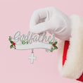 Load image into Gallery viewer, Decorative brooch with 'Godfather' text and cross charm held by a gloved hand on a pink background
