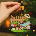 Load image into Gallery viewer, Personalized gardener ornament featuring a detailed garden scene with wooden fence wheelbarrow potted plants gardening tools and soil elements. The design includes a customizable name on the fence and a year on the base making it a thoughtful keepsake for garden lovers. The ornament has a warm rustic farmhouse style and is displayed with a red hanging ribbon suitable for Christmas trees seasonal decor and gift displays.
