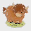 Load image into Gallery viewer, Adorable Highland cow themed Christmas ornament featuring a fluffy brown cow design with soft rounded details and a warm countryside feel. Styled in a natural green meadow setting, this ornament is designed to be personalized and brings a cozy farm inspired charm to holiday tree decor.

