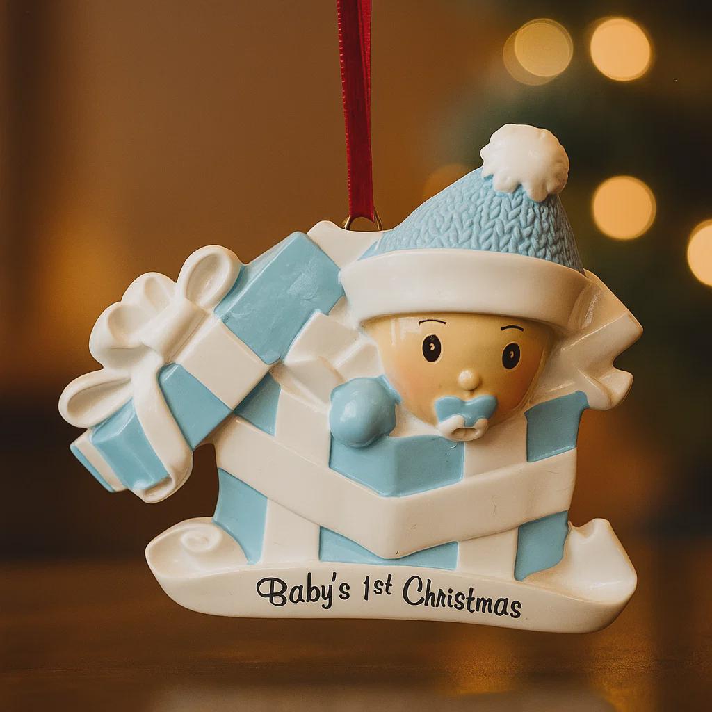 Personalized Baby Boy First Christmas Ornament featuring an adorable baby popping out of a blue gift box with a matching hat and pacifier. The name is displayed on the hat while the year is placed on the ribbon detail, with Baby’s 1st Christmas written along the base. Soft blue and white tones, raised 3D elements, and sweet holiday details make this a charming keepsake. Perfect for newborn boys, baby showers, and celebrating a baby’s very first Christmas season.