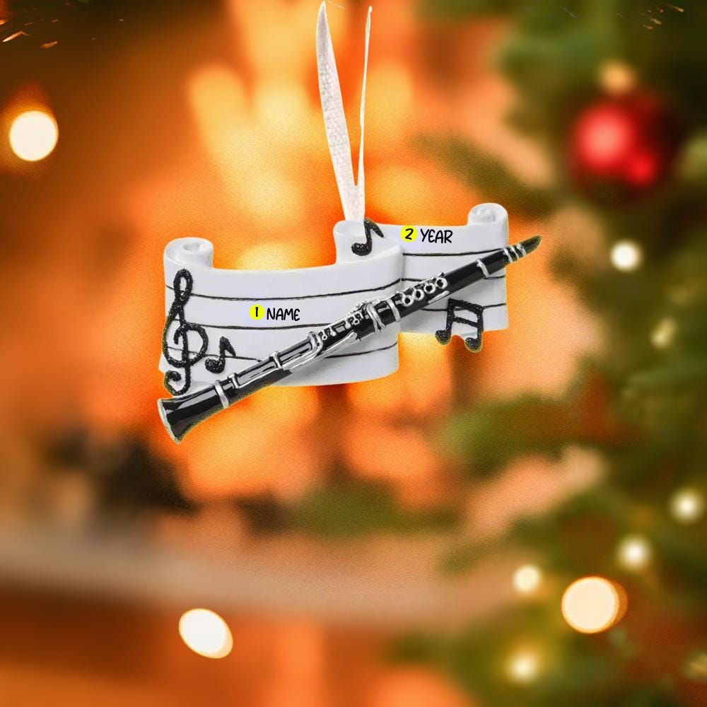 Decorative clarinet ornament with customizable text on a blurred Christmas tree and lights background.